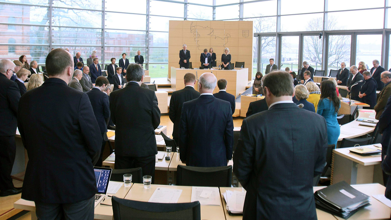 Abgeordnete des Landtages gedenken stehend der Opfer des  Terrorattentats von Hanau in Hessen.