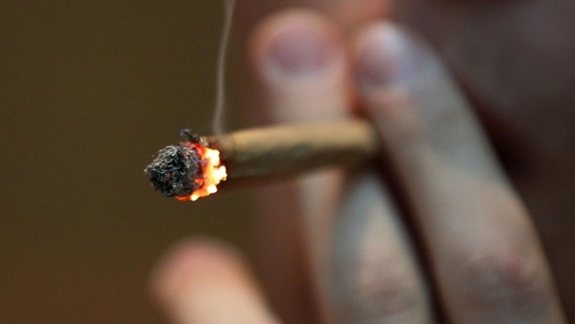 Ein Mann raucht einen Joint.