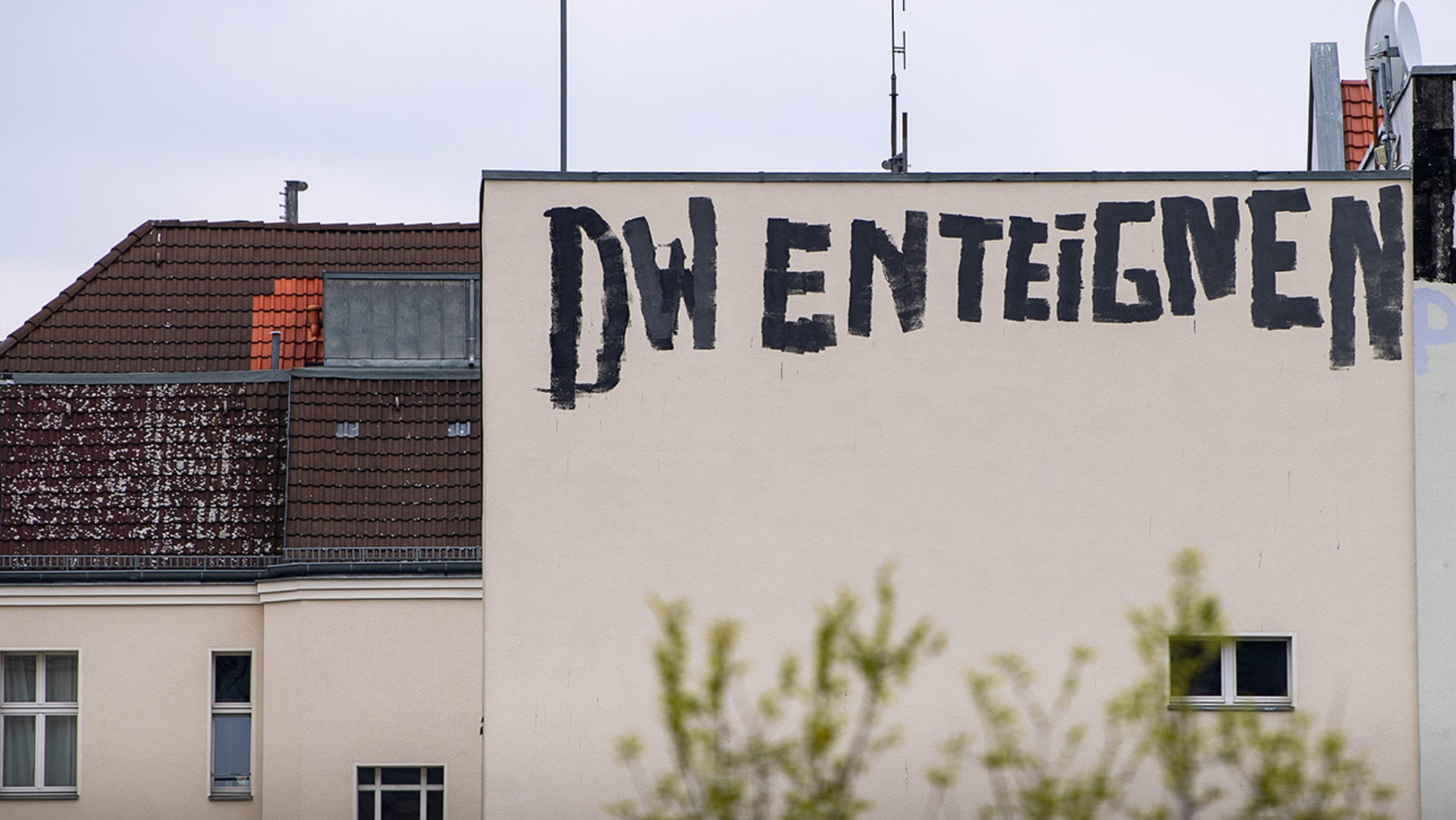 Der Schriftzug "DW enteignen" steht auf einer Hausmauer.
